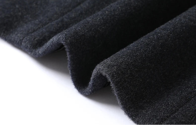 Close-up of dark gray fabric with a pocket close-up on a white background