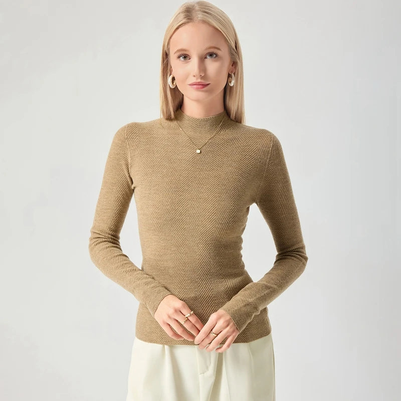 Woman wearing a brown sweater against a plain background