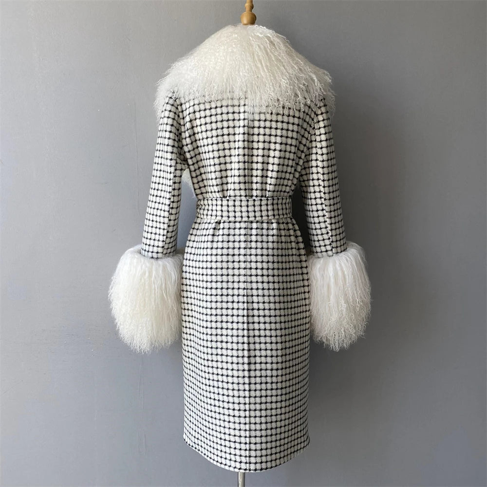 Black and white checkered coat with fluffy white cuffs and collar on a mannequin against a gray background