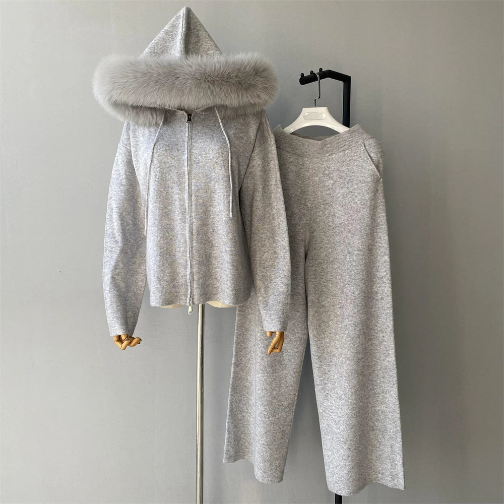 Gray hooded outfit with fur trim on a mannequin against a plain background