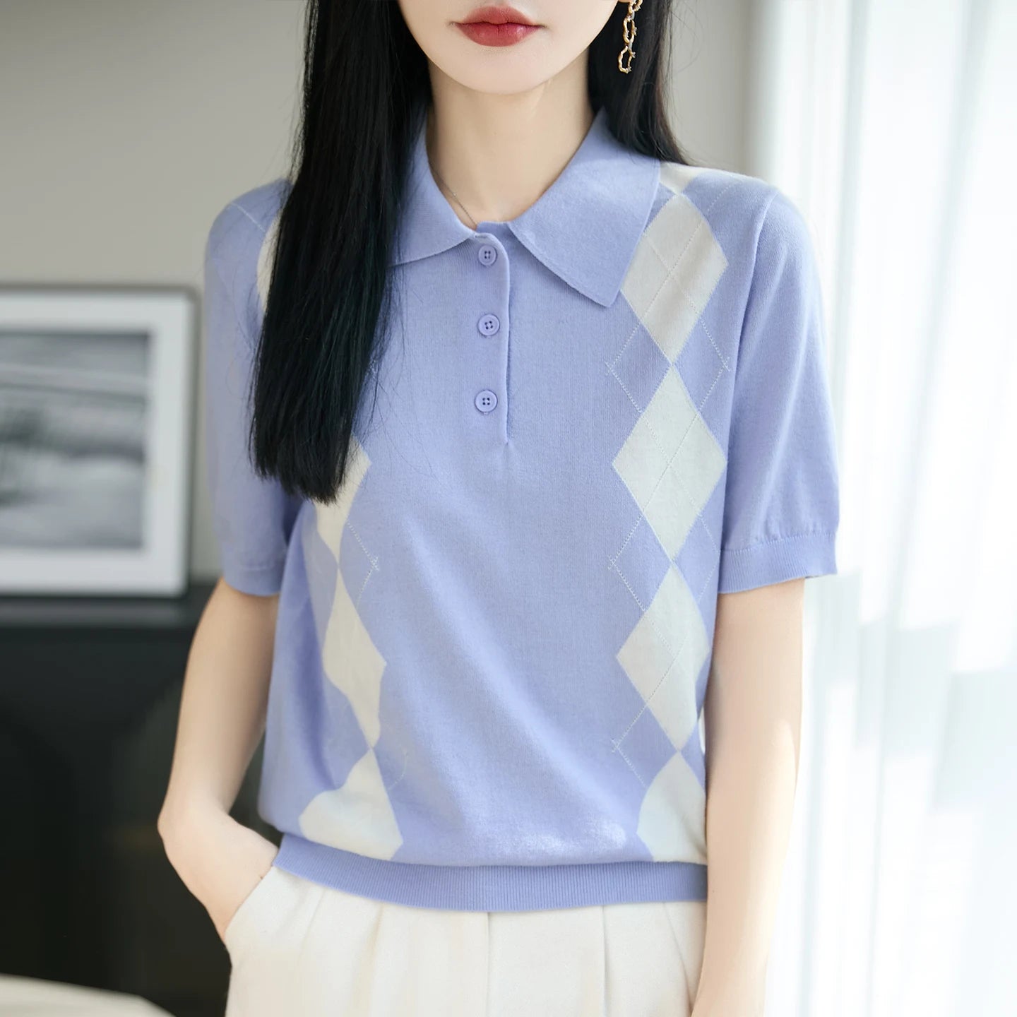Woman wearing a light blue and white patterned shirt indoors
