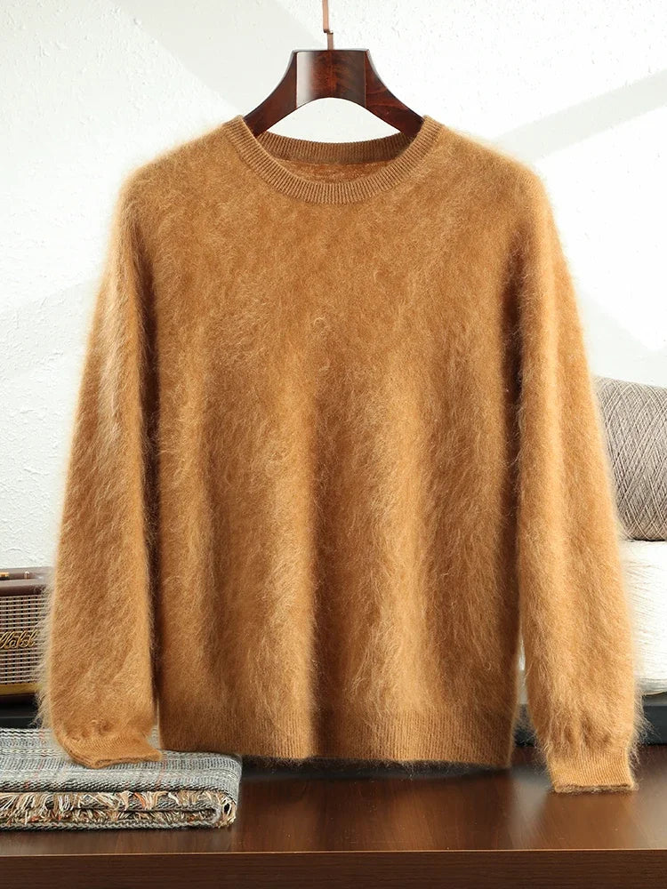 Brown fuzzy sweater on a hanger against a white brick wall.
