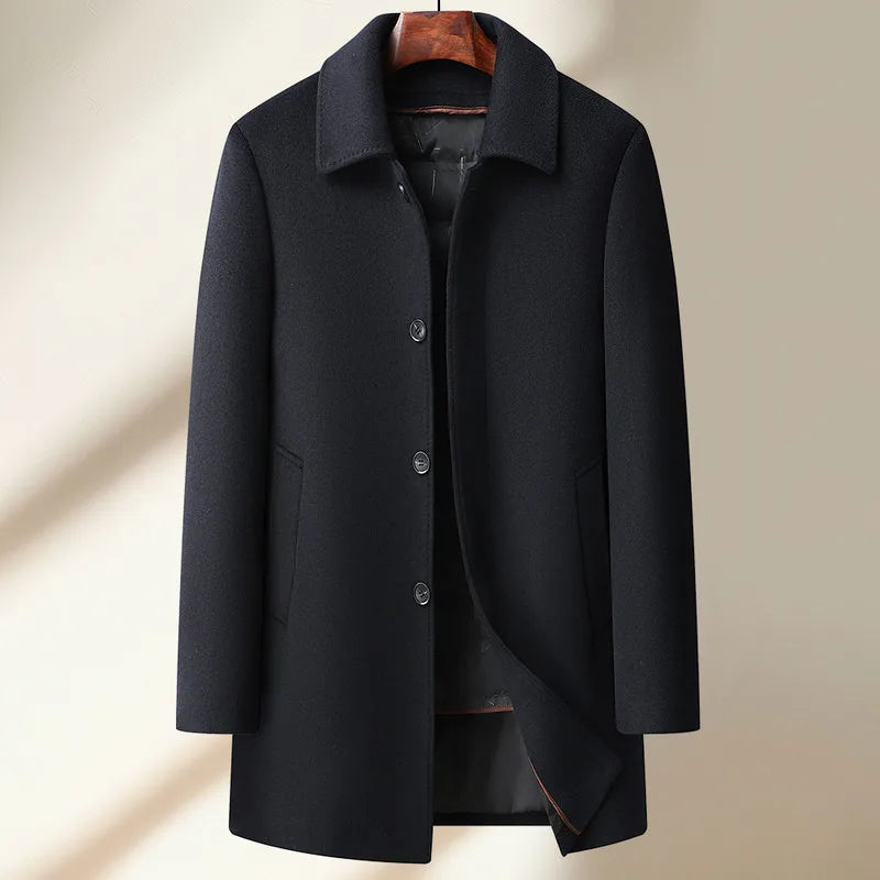 Black coat on a hanger against a beige background