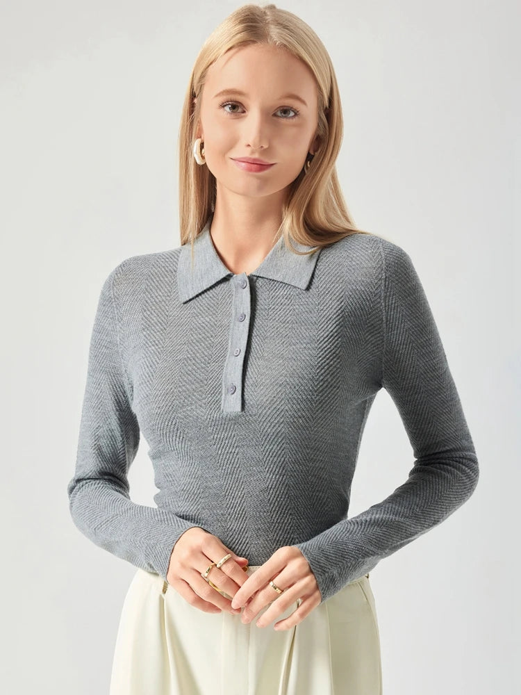 Woman wearing a gray long-sleeve knit polo shirt against a light background