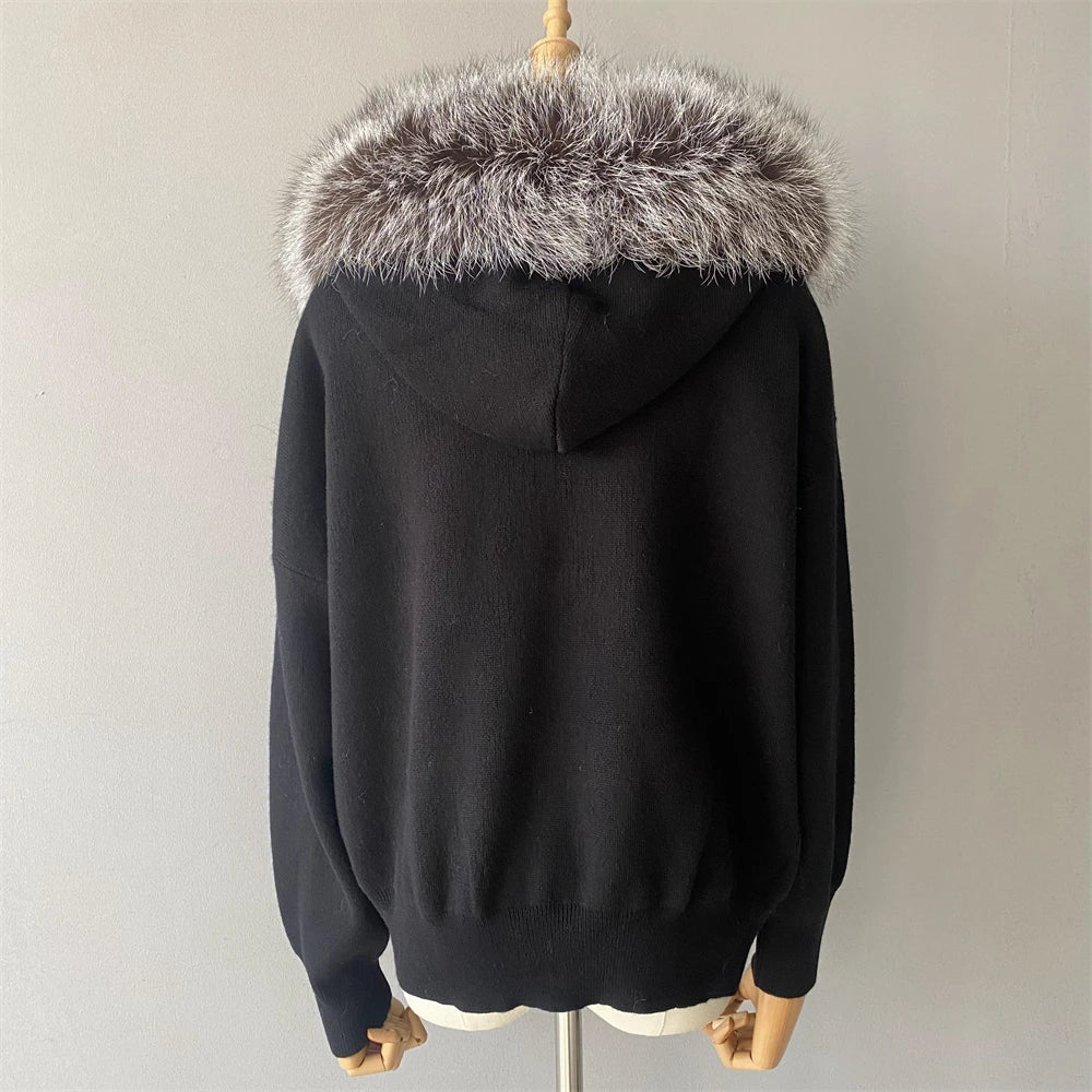 Black hoodie with fur-lined hood on a mannequin against a plain background