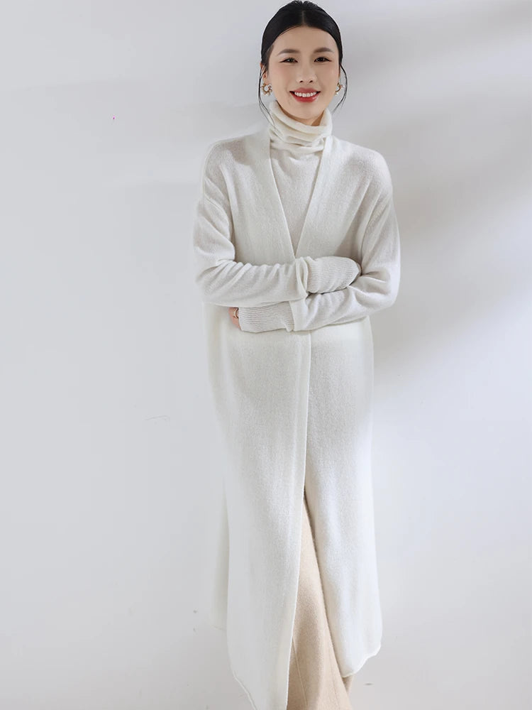 Woman wearing a long, light-colored coat against a white background