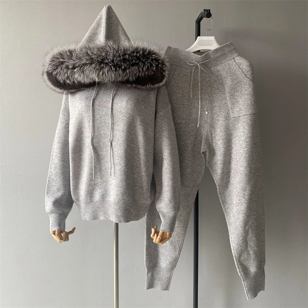 Gray hoodie and jogger set with fur-lined hood on a mannequin against a plain background