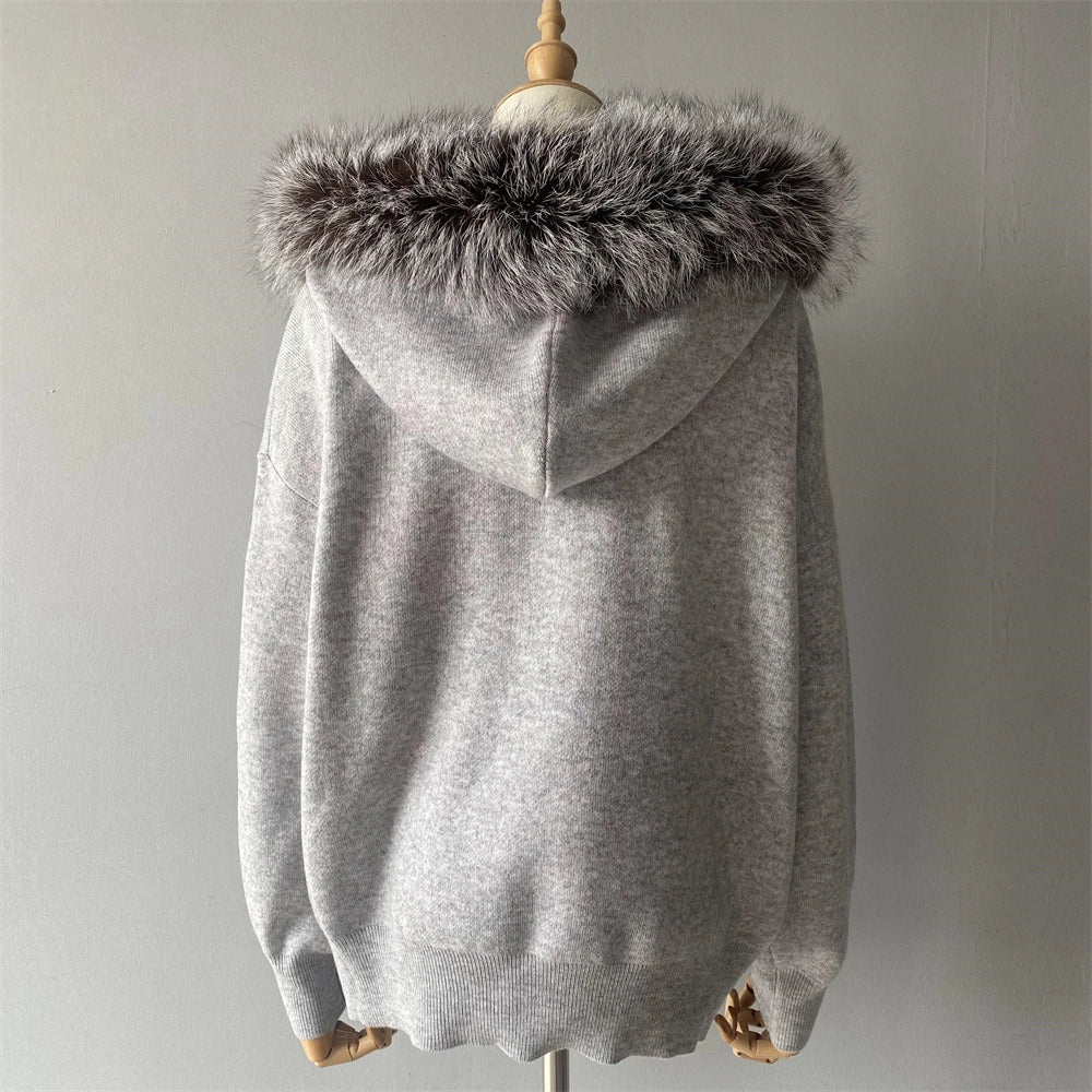 Gray hoodie with fur hood on a mannequin against a plain background