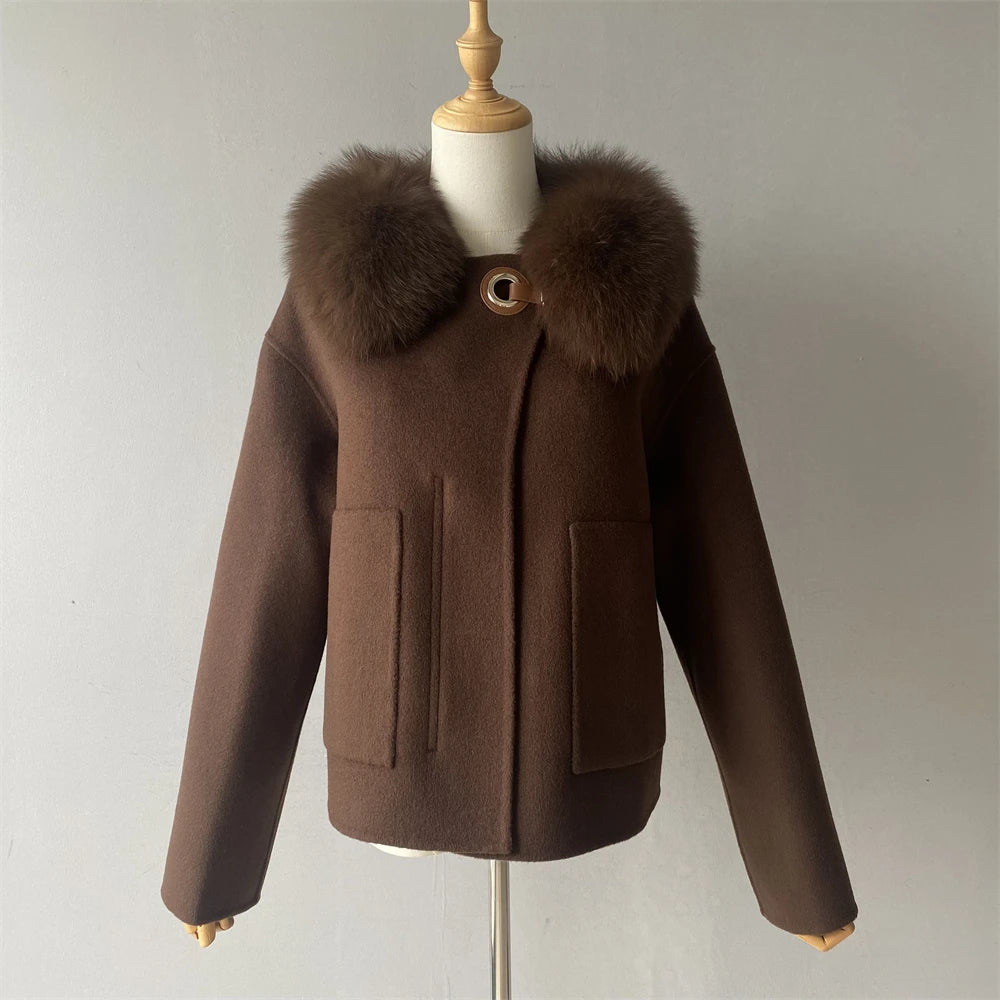 Brown coat with fur collar on a mannequin against a plain background