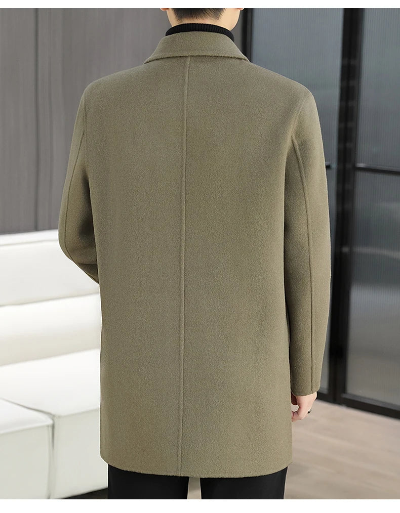 Person wearing a green coat standing in a minimal indoor setting