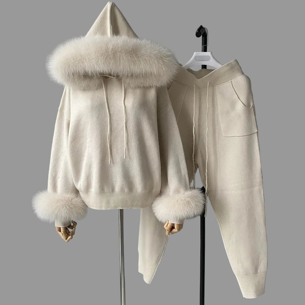 Beige hoodie with fur trim and matching pants on a gray background
