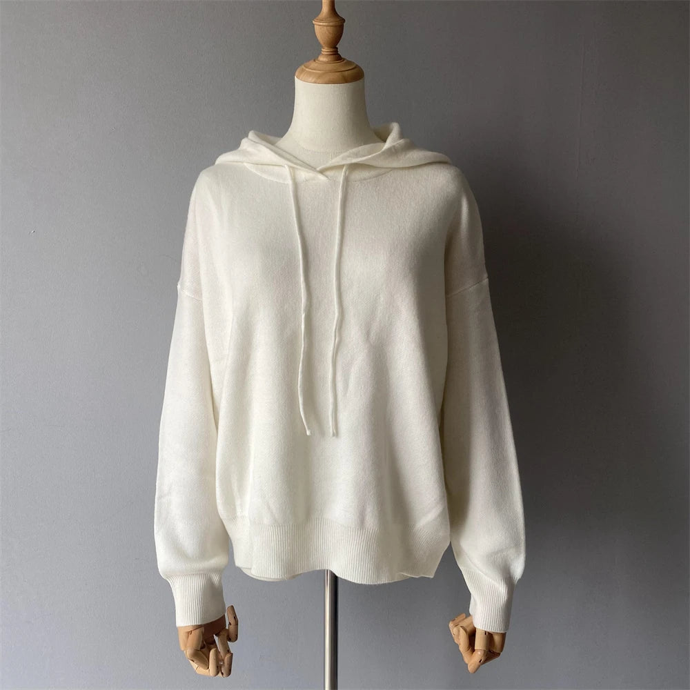 White hoodie on a mannequin against a gray background