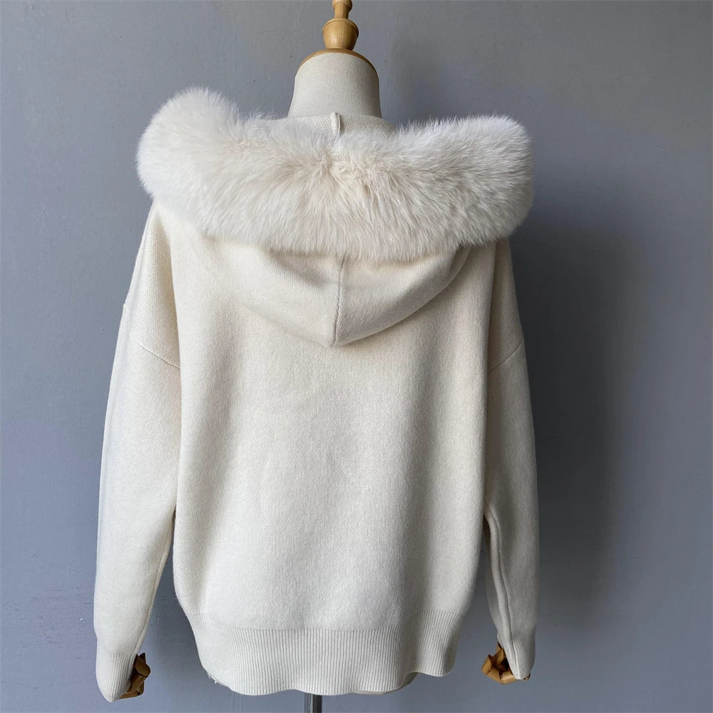White hooded jacket with fur collar on a mannequin against a gray background