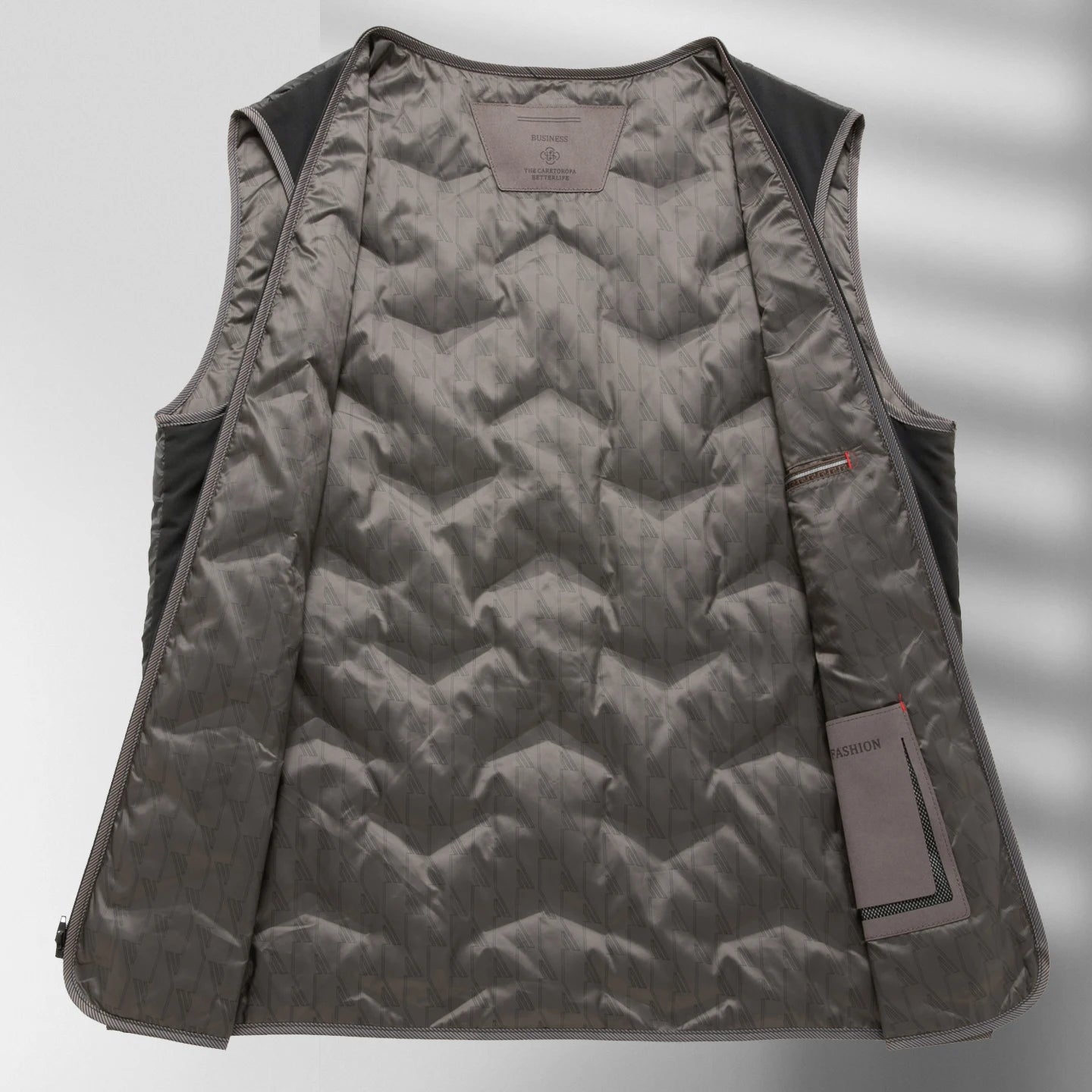 Gray quilted vest with a brand tag on a light gray background