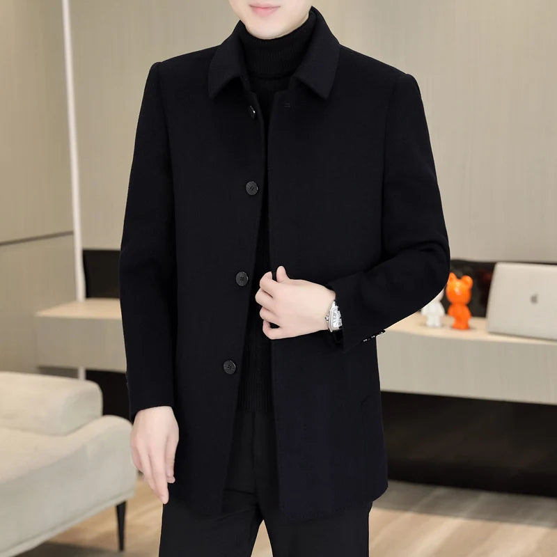 Person wearing a black coat in an indoor setting