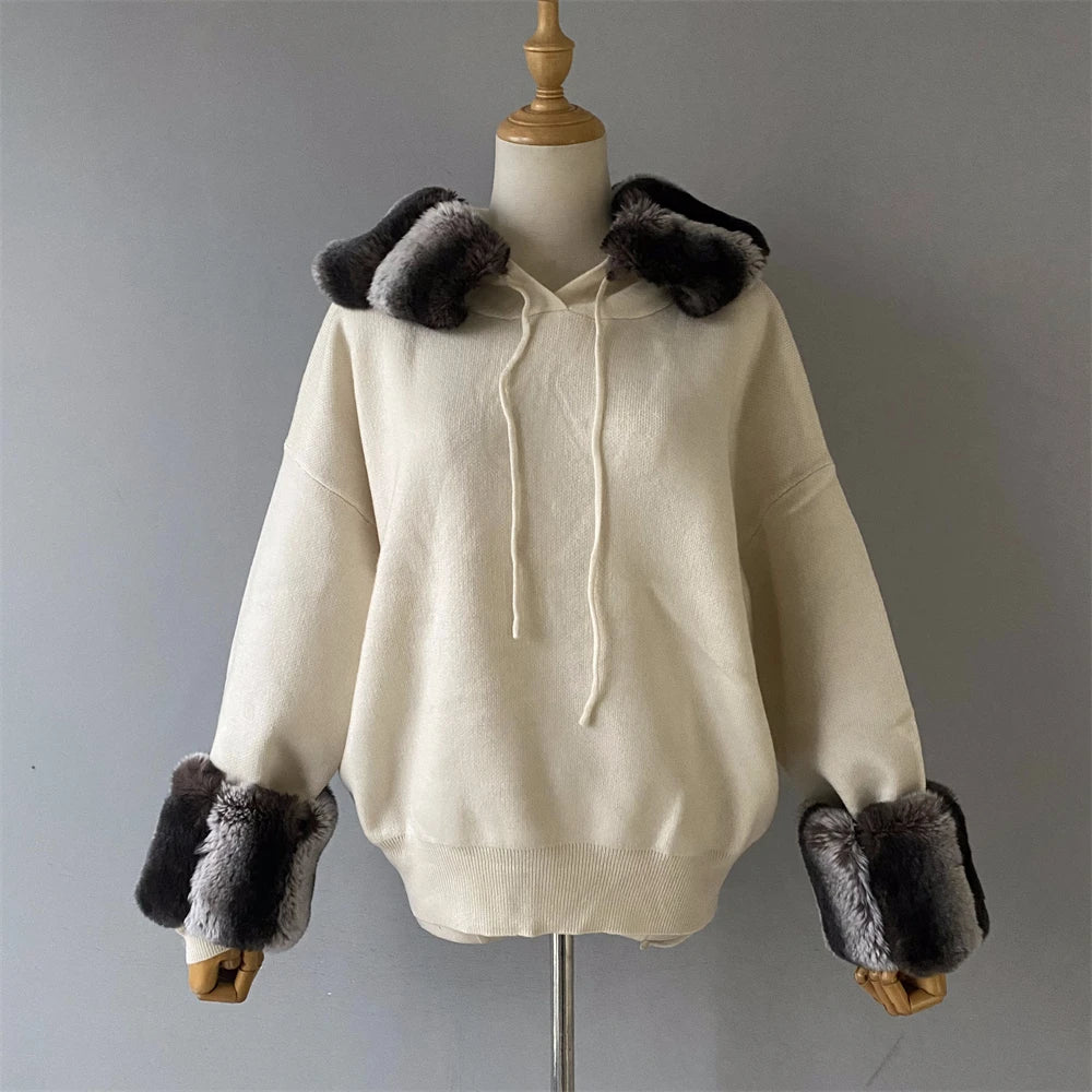 Beige hoodie with fur trim on a mannequin against a gray background