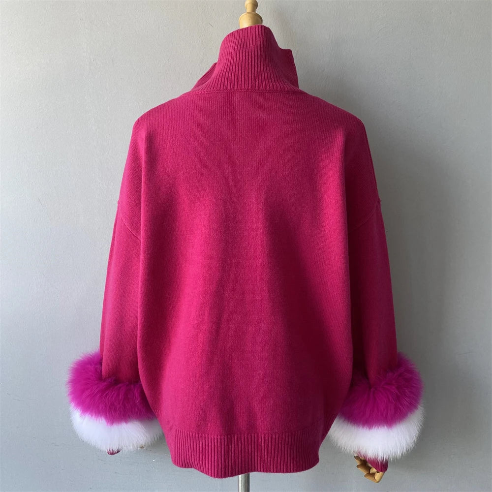 Pink sweater with fur cuffs on a mannequin against a plain background