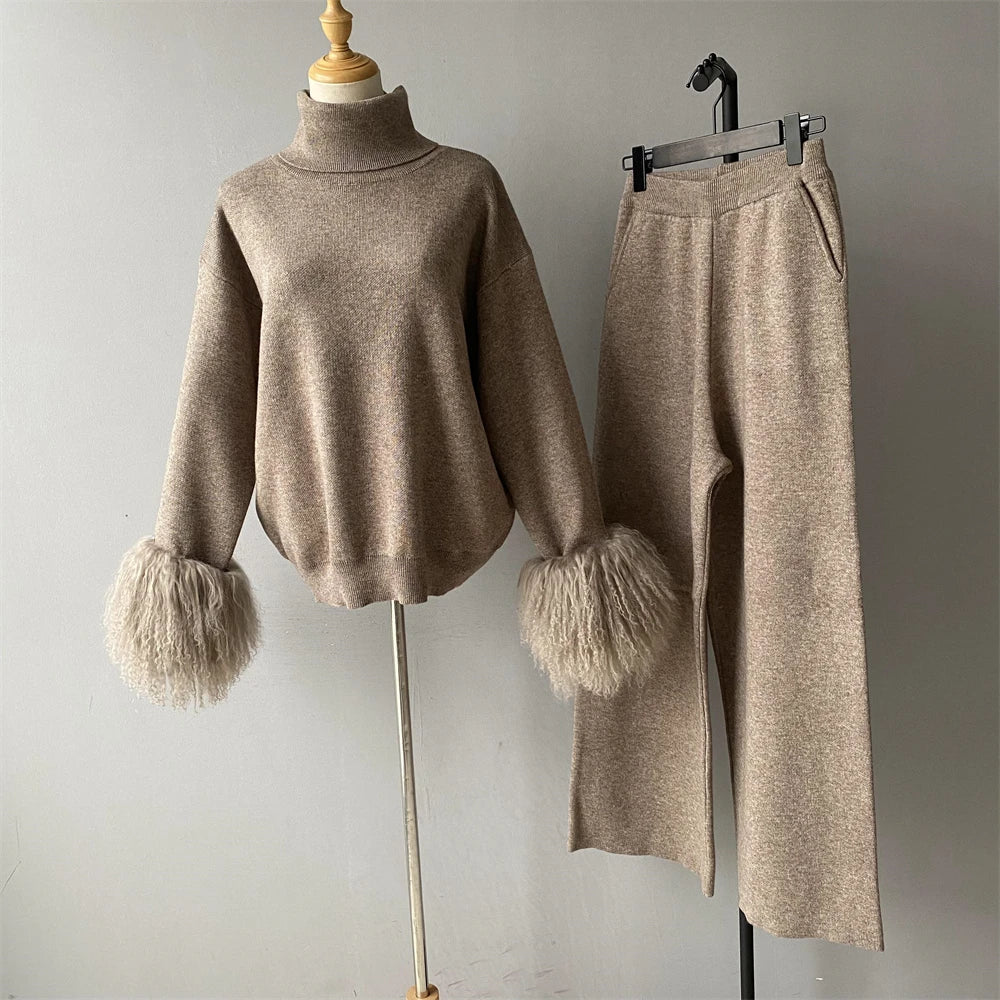 Beige sweater with fluffy cuffs and matching pants on a mannequin against a gray background