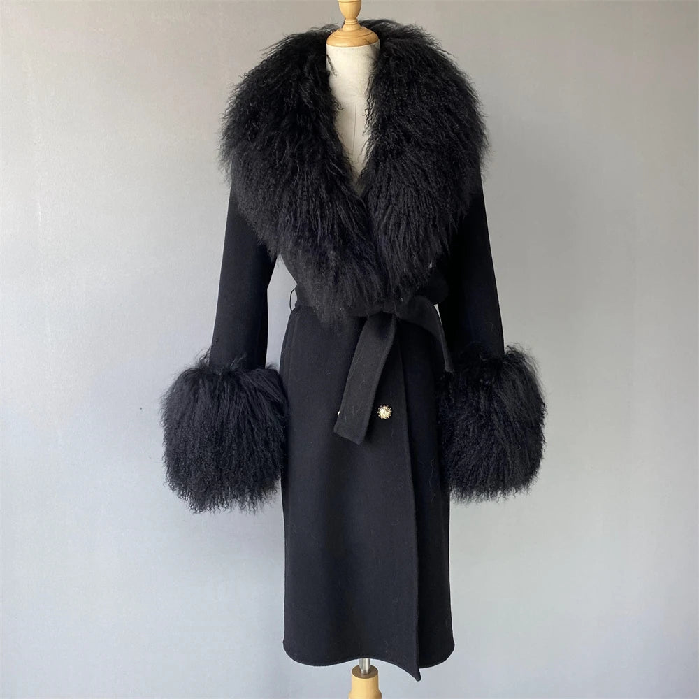 Black coat with fur trim on a mannequin against a plain background