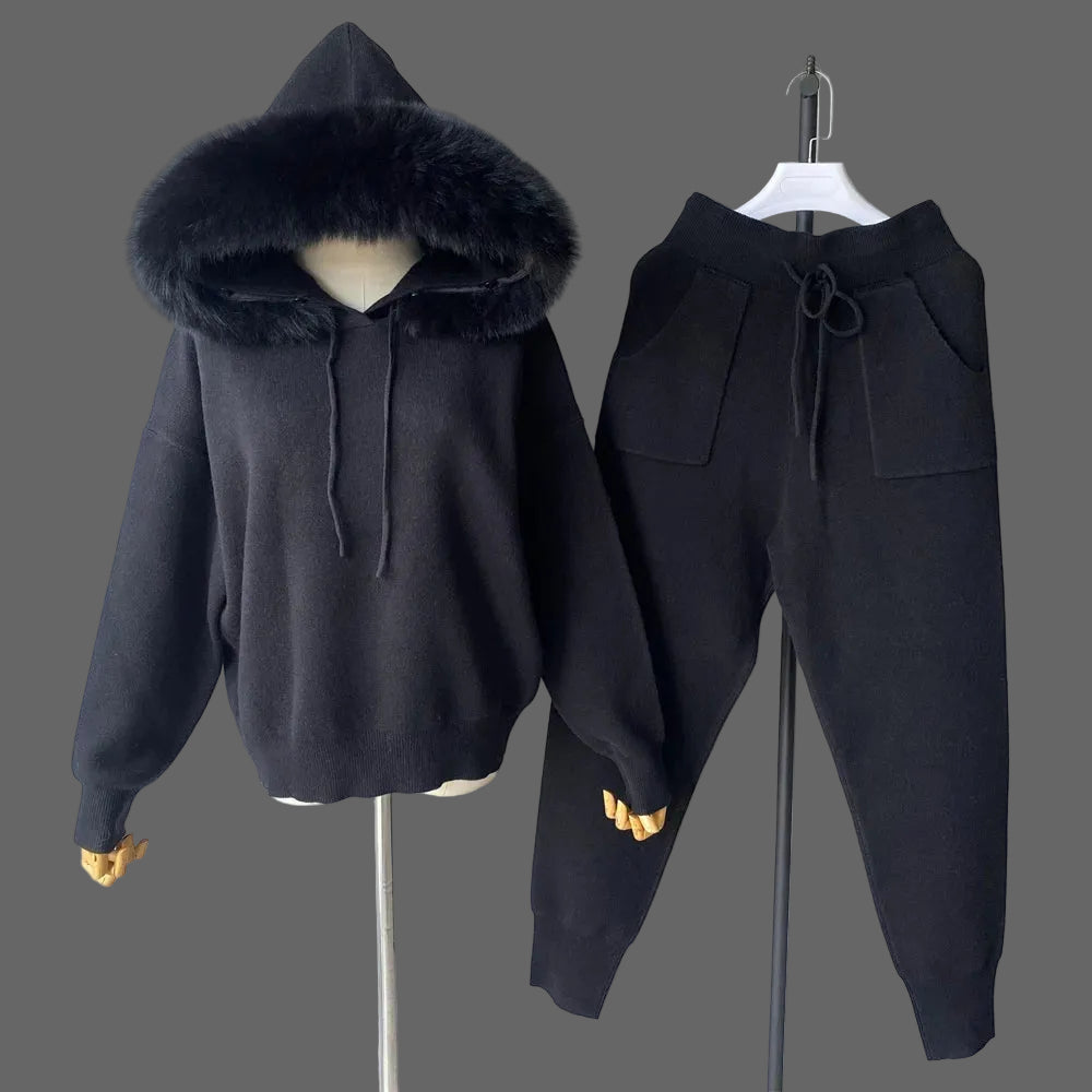 Black hoodie and pants set with fur-lined hood on a mannequin against a plain background.