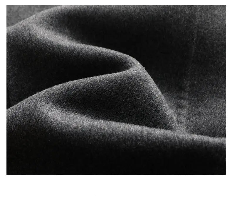 Close-up of dark fabric with visible texture and folds.