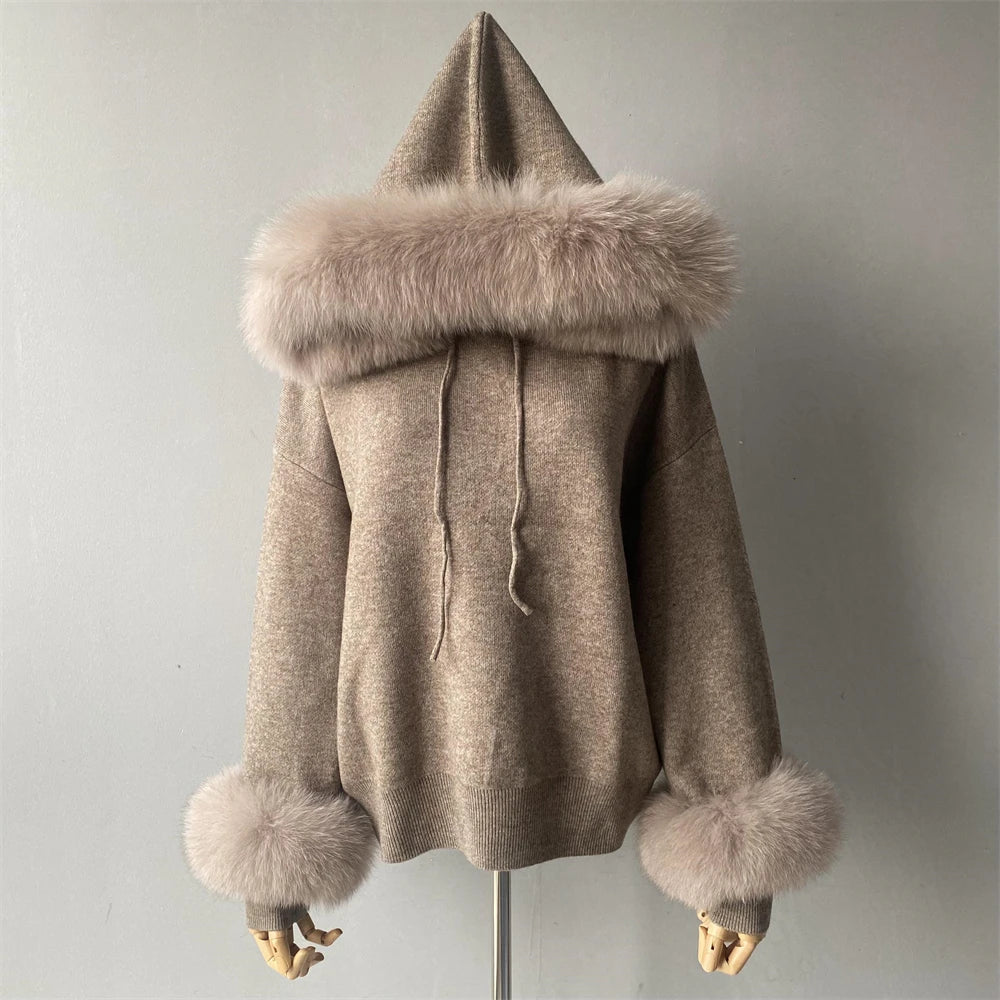 Beige hooded coat with fur trim on a mannequin against a plain background