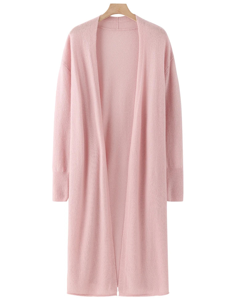 Pink cardigan on a hanger against a white background