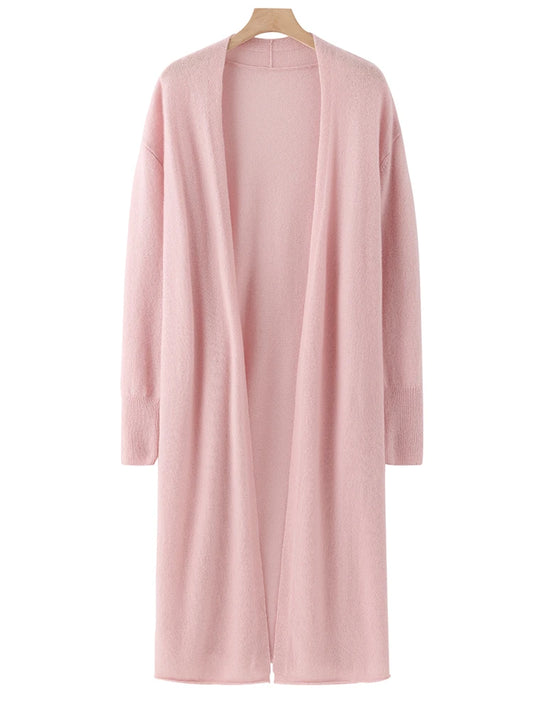 Pink cardigan on a hanger against a white background