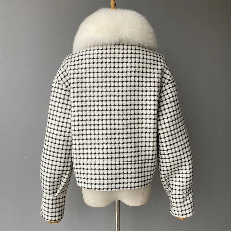 Black and white checkered jacket with fur hood on a mannequin against a gray background